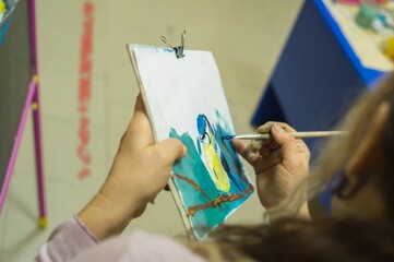 Drawing lesson.  Teacher shows how to draw with gouache
