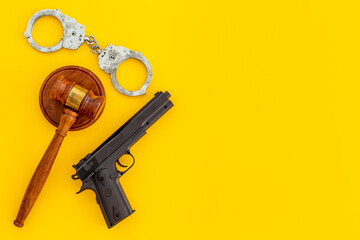 Hand gun weapon with handcuffs - illegal use of weapons concept