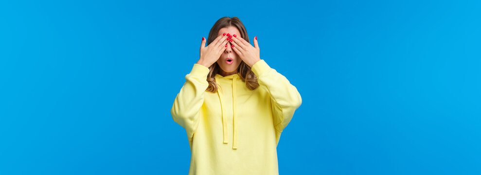 Girl Fool Around In Playful Mood, Close Eyes With Hands Count To Ten, Playing Hide N Seek Or Peekaboo, Waiting For Surprise Gift, Express Curiosity And Interest, Stand Blue Background Awaiting