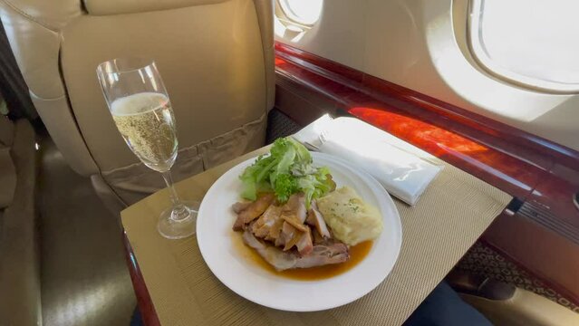 inside a luxury business jet with fresh deligoues food prepared for the VIP passengers, including sparkling champagne - k4 video