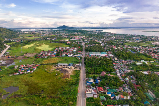 Early morning aerial of the Pan-Philippine highway with the city of Tacloban in the distance.