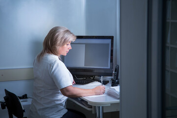 a woman is sitting at a computer in an office or something office