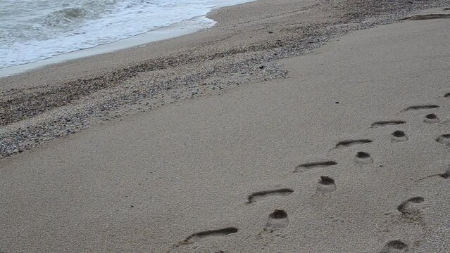 Traces of the person on a beach. Tourists traces
