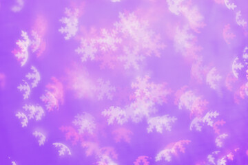 Fototapeta na wymiar Bokeh as lights white pink stars on lavender color background, happy winter holiday wallpaper with bright blurred pattern. Happy Christmas or New Year magic light aesthetic photo, neon colors