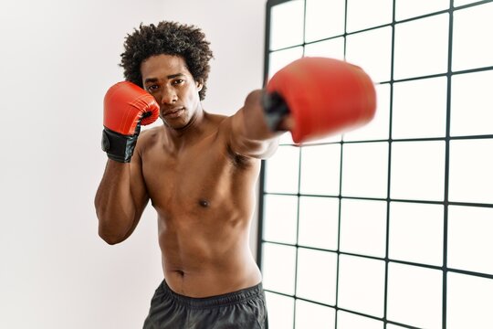 Young african american man boxing at gym