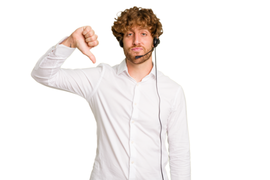 Telemarketer man working with a headset isolated on green chroma background showing a dislike gesture, thumbs down. Disagreement concept.