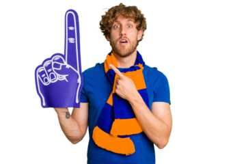 Young caucasian sports fan man isolated on white background pointing to the side