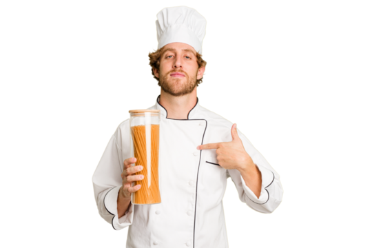 Young cook man isolated on white background person pointing by hand to a shirt copy space, proud and confident