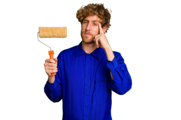 Young painter man holding a roll isolated on white background pointing temple with finger, thinking, focused on a task.