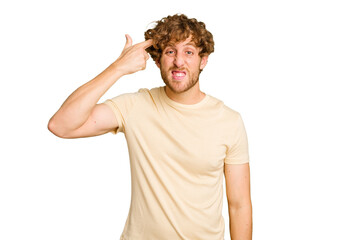 Young caucasian man isolated on green chroma background showing a disappointment gesture with forefinger.