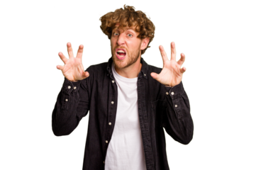 Young caucasian man isolated on green chroma background upset screaming with tense hands.