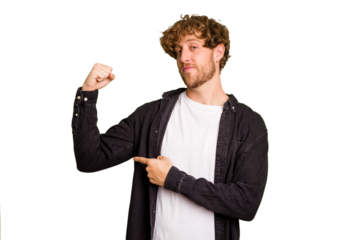 Young caucasian man isolated on green chroma background showing strength gesture with arms, symbol of feminine power