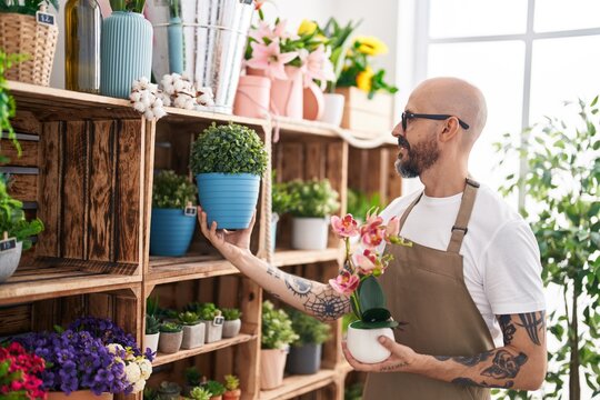 Young Bald Man Florist Smiling Confident Holding Plants At Florist