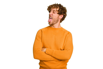 Young caucasian man isolated on green chroma background funny and friendly sticking out tongue.