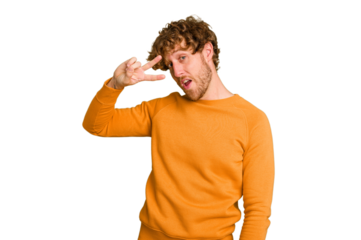 Young caucasian man isolated on green chroma background dancing and having fun.