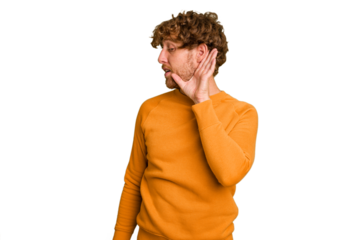 Young caucasian man isolated on green chroma background trying to listening a gossip.