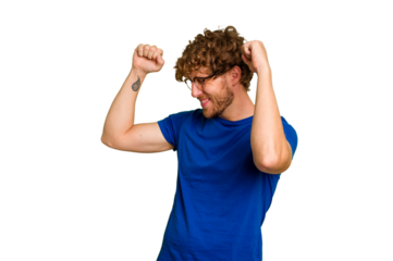Young caucasian man isolated on green chroma background celebrating a special day, jumps and raise arms with energy.
