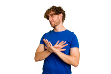 Young caucasian man isolated on green chroma background doing a denial gesture