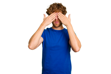 Young caucasian man isolated on green chroma background afraid covering eyes with hands.