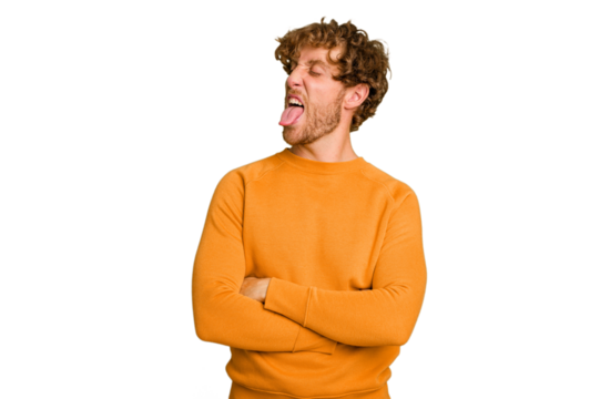 Young caucasian man isolated on green chroma background funny and friendly sticking out tongue. - Powered by Adobe