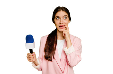 Young TV presenter caucasian woman isolated relaxed thinking about something looking at a copy space.