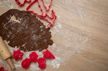 Gingerbread dough for Christmas cookies and cookie cutters.