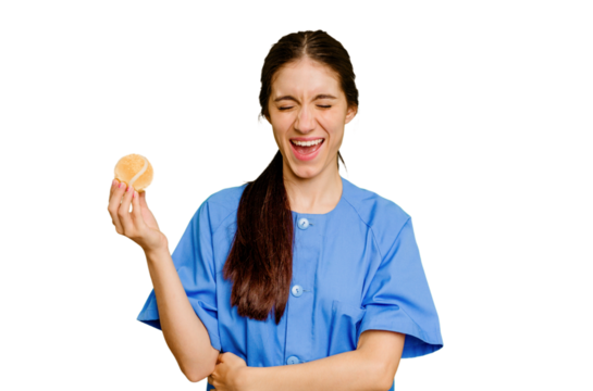Young caucasian physiotherapist woman holding a tennis ball isolated screaming very angry and aggressive.