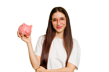 Young caucasian woman holding a piggy bank isolated happy, smiling and cheerful.
