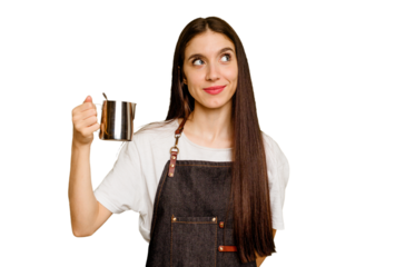 Young barista caucasian woman isolated dreaming of achieving goals and purposes