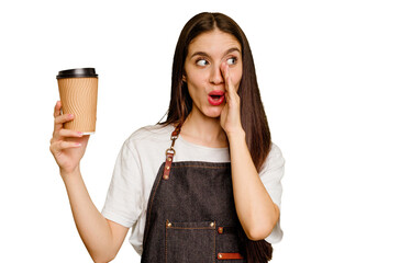 Young barista woman holding a takeaway coffee isolated is saying a secret hot braking news and...