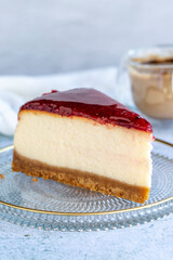 Cheese cake. Bakery products. Cheesecake with raspberry on a gray background. close up