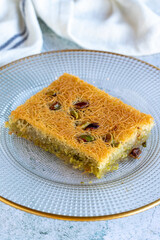 Pistachio Kadaif dessert. Traditional Mediterranean cuisine delicacies. Kadayif on gray background. close up
