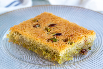 Pistachio Kadaif dessert. Traditional Mediterranean cuisine delicacies. Kadayif on gray background. close up