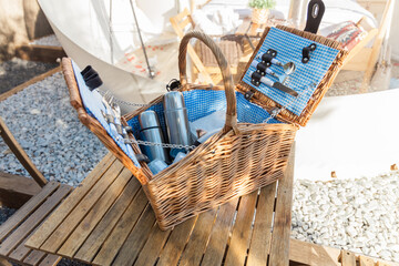 Picnic basket on table near tent