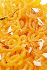 Close-Up of Indian Classical  Sweet Jalebi . Garnished with kesar (Saffron) and dry nuts, Jalebi is one of the most delicious sweets widely used in India. Selective Focus on Subject,