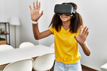 African american girl playing video game using vr glasses at home