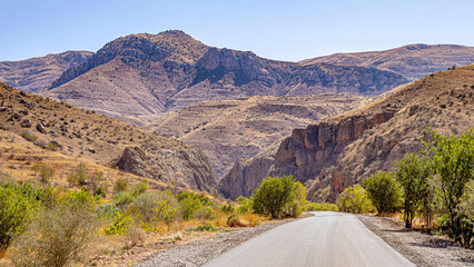 Asphalt road running among high mountains