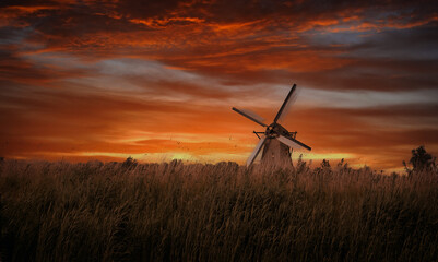 Old windmills in Kinderdijk at dramatic sunset, Netherland