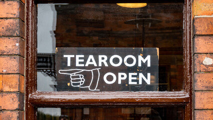 Fototapeta premium Tea room open sign in old wooden sash window