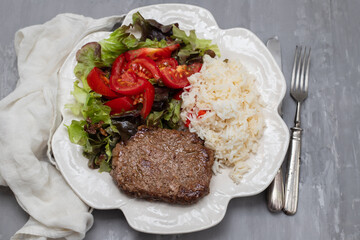 three fried ground meat with fresh salad on white plate