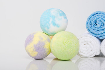 close-up of multicolored bath salts, in the form of bombs and towels rolled up for spa treatments
