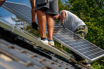 Men worker installing solar photovoltaic panels on roof, alternative energy, saving resources and...