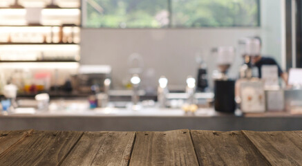 Wood top table with Blur coffee shop or cafe restaurant with abstract bokeh light image background. People in store Blur Background or design key visual layout