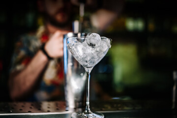 Ice cube in an empty glass on a bar counter in bar or pub