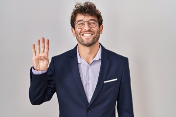 Hispanic business man wearing glasses showing and pointing up with fingers number four while smiling confident and happy.