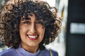 Young middle east woman smiling confident at street