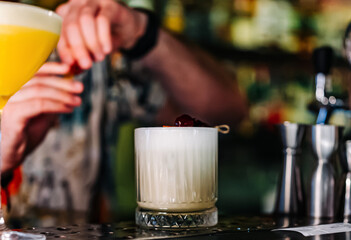 man hand bartender making white cocktail in glass on the bar counter