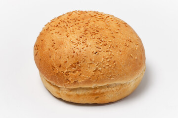 white bun with sesame seeds on a white background