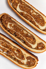 three slices of sweet bread with apples and nuts on a white background top view