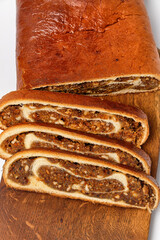 sweet bread with apple and nuts on a kitchen board on a white background close view